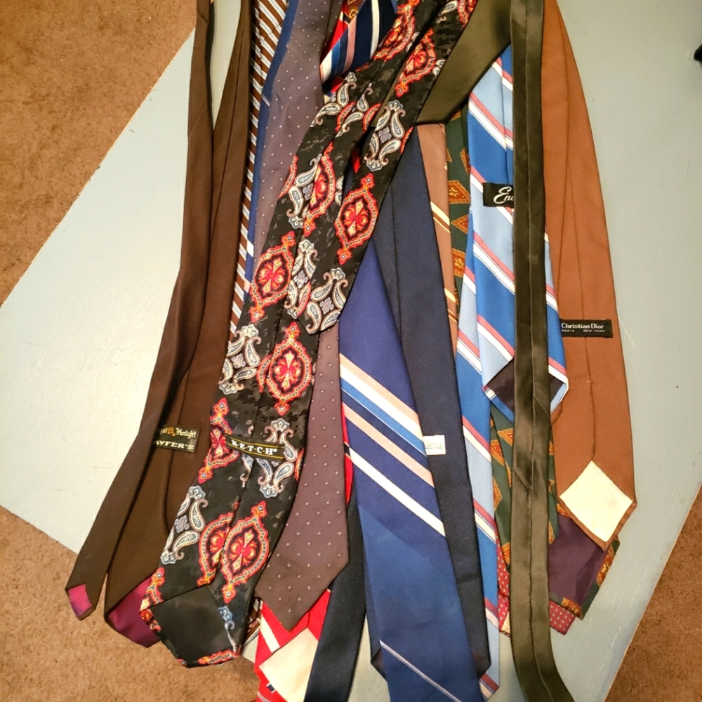 A giant pile of men's ties, name brands such as Christian Dior, oleg, ect.